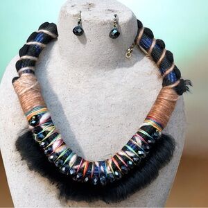 Makarlon necklace with black beads, colorful thread details, and real fur trim